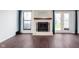Cozy living room featuring a fireplace, French doors, and hardwood floors throughout the space at 9467 Sandpiper W Dr, Indianapolis, IN 46268