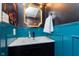 Chic powder room features designer wallpaper, sleek fixtures, and modern vanity at 9467 Sandpiper W Dr, Indianapolis, IN 46268
