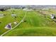 Aerial view of a playground, sports fields, and a pond in a neighborhood at 1051 Margate Dr, Greenwood, IN 46143