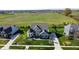 Beautifully landscaped home boasts mature trees, stone accents, and an inviting curb appeal with a sprawling green lawn at 1051 Margate Dr, Greenwood, IN 46143