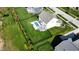 The aerial view captures a fenced backyard with an in-ground pool, patio, and lush landscaping at 1051 Margate Dr, Greenwood, IN 46143