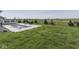 Expansive backyard includes a sleek pool, elegant patio, and a barbecue area, all surrounded by lush green lawn at 1051 Margate Dr, Greenwood, IN 46143