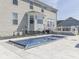 Enjoy the backyard oasis with its chic pool featuring fountain accents and a beautifully designed deck area at 1051 Margate Dr, Greenwood, IN 46143