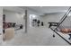 Finished basement offers a pinball machine, sports games, an office area, and access to the stairs at 1051 Margate Dr, Greenwood, IN 46143