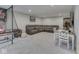 Basement seating area features a large sectional couch, a gaming area, and a dining table at 1051 Margate Dr, Greenwood, IN 46143