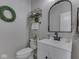 Powder room featuring modern vanity, updated fixtures, arched mirror, and decorative accents at 1051 Margate Dr, Greenwood, IN 46143