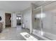 Bathroom featuring walk-in shower with glass door, tile flooring, and view into another room at 1051 Margate Dr, Greenwood, IN 46143