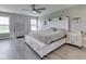 Spacious bedroom with a decorative headboard, ceiling fan, and natural light at 1051 Margate Dr, Greenwood, IN 46143