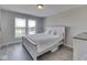 Well-lit bedroom featuring a large window, plank flooring, and neutral color palette at 1051 Margate Dr, Greenwood, IN 46143