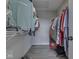 Walk-in closet featuring clothes hanging from racks, overhead light, and ample storage space at 1051 Margate Dr, Greenwood, IN 46143