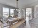 Sun-filled dining area features a wood table and bench with views from large windows at 1051 Margate Dr, Greenwood, IN 46143