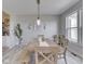 Bright dining room boasts wood table, bench, and chairs under a pendant light fixture at 1051 Margate Dr, Greenwood, IN 46143