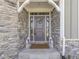 Inviting front entrance featuring stone accents, decorative lanterns, and a charming wreath at 1051 Margate Dr, Greenwood, IN 46143