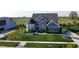 Stunning home with meticulously landscaped front yard, charming architectural details, and inviting curb appeal at 1051 Margate Dr, Greenwood, IN 46143