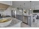 Well-lit kitchen showcasing a gray island, stainless steel appliances, granite countertops and open access to the living room at 1051 Margate Dr, Greenwood, IN 46143