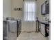Well-organized laundry room with modern washer, dryer, and cabinet storage space at 1051 Margate Dr, Greenwood, IN 46143
