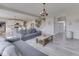 Open-concept living area with modern sofas, a coffee table, and views of the kitchen at 1051 Margate Dr, Greenwood, IN 46143