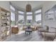 Sunlit sitting area featuring large windows, wicker furniture, and stylish decor at 1051 Margate Dr, Greenwood, IN 46143