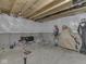 Unfinished basement with exposed wood beams and concrete walls offers potential for customization at 1051 Margate Dr, Greenwood, IN 46143