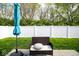 Backyard patio with a seating area, an umbrella for shade, and a privacy fence at 10538 Rose Mill Dr, Lawrence, IN 46235