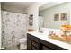 Bright bathroom with Paris-themed shower curtain, vanity storage, and decorative items at 10538 Rose Mill Dr, Lawrence, IN 46235