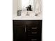 Modern bathroom vanity with dark wood cabinets, white countertop, and sleek hardware for a contemporary look at 10538 Rose Mill Dr, Lawrence, IN 46235