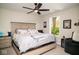 Bright bedroom featuring a ceiling fan, a comfortable bed, and natural light from a window at 10538 Rose Mill Dr, Lawrence, IN 46235