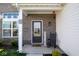 Welcoming front porch with a charming rocking chair and decorative touches at 10538 Rose Mill Dr, Lawrence, IN 46235