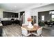 Modern kitchen with stainless steel appliances, dark cabinetry, and an adjacent dining area at 10538 Rose Mill Dr, Lawrence, IN 46235
