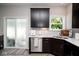 Stylish kitchen with stainless steel appliances, white countertops, dark cabinets, and a sliding door to the outdoor at 10538 Rose Mill Dr, Lawrence, IN 46235