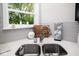 Well-lit kitchen sink area featuring a stainless steel sink, faucet, white backsplash, and a view of the outdoors at 10538 Rose Mill Dr, Lawrence, IN 46235
