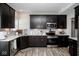 Modern kitchen boasts dark cabinetry, stainless steel appliances, white countertops, and sleek finishes for a contemporary cooking space at 10538 Rose Mill Dr, Lawrence, IN 46235