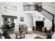 Spacious living room with a staircase, modern decor, and views of the dining area at 10538 Rose Mill Dr, Lawrence, IN 46235