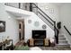 Well-lit living room featuring a staircase, sleek television and stylish decorative accents at 10538 Rose Mill Dr, Lawrence, IN 46235