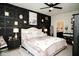 Comfortable main bedroom with a stylish black accent wall and ceiling fan, with plenty of natural light at 10538 Rose Mill Dr, Lawrence, IN 46235