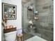 Modern tiled shower with glass door, showcasing stylish fixtures, and a convenient shower caddy for organization at 10538 Rose Mill Dr, Lawrence, IN 46235