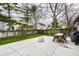 Spacious backyard featuring a concrete patio and a wooden picnic table, perfect for outdoor gatherings at 106 W Delaware St, Fortville, IN 46040