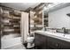 Bathroom featuring a double sink vanity, stylish mirror and lighting, and a shower-tub combo at 106 W Delaware St, Fortville, IN 46040