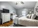 Stylish primary bedroom featuring neutral tones, decorative accents, and a large window at 106 W Delaware St, Fortville, IN 46040