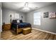 Comfortable bedroom with hardwood floors, a ceiling fan, and a sunny window at 106 W Delaware St, Fortville, IN 46040
