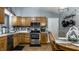 Modern kitchen with stainless steel appliances, wooden cabinets, and an adjacent breakfast nook at 106 W Delaware St, Fortville, IN 46040