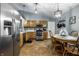 Eat-in kitchen with wooden cabinetry, stainless steel appliances, and a cozy dining area at 106 W Delaware St, Fortville, IN 46040