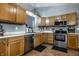 Well-lit kitchen featuring stainless steel appliances, ample counter space, and plenty of wooden cabinetry at 106 W Delaware St, Fortville, IN 46040