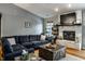 Inviting living room with a large sectional couch, brick fireplace, and stylish coffee table at 106 W Delaware St, Fortville, IN 46040