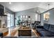 Bright and open living space with hardwood floors, a comfy recliner and sliding glass doors at 106 W Delaware St, Fortville, IN 46040