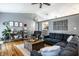 Well-decorated living room featuring a sectional sofa, hardwood floors, and a decorative console table at 106 W Delaware St, Fortville, IN 46040