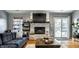 Cozy living area with brick fireplace, modern shelving, and sliding glass doors to the backyard at 106 W Delaware St, Fortville, IN 46040