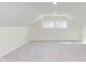 Spacious attic area with clean carpeting, bright natural light, and neutral paint at 10745 Southeastern Ave, Indianapolis, IN 46239
