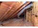 Exposed attic space with wooden beams and ductwork, showing potential for renovation at 10745 Southeastern Ave, Indianapolis, IN 46239