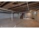 Unfinished basement with a wooden staircase and exposed ceilings, perfect for storage at 10745 Southeastern Ave, Indianapolis, IN 46239